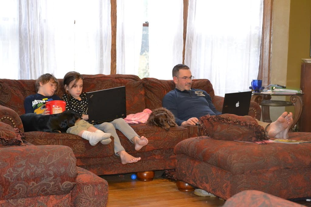 Family relaxing on a sofa at home