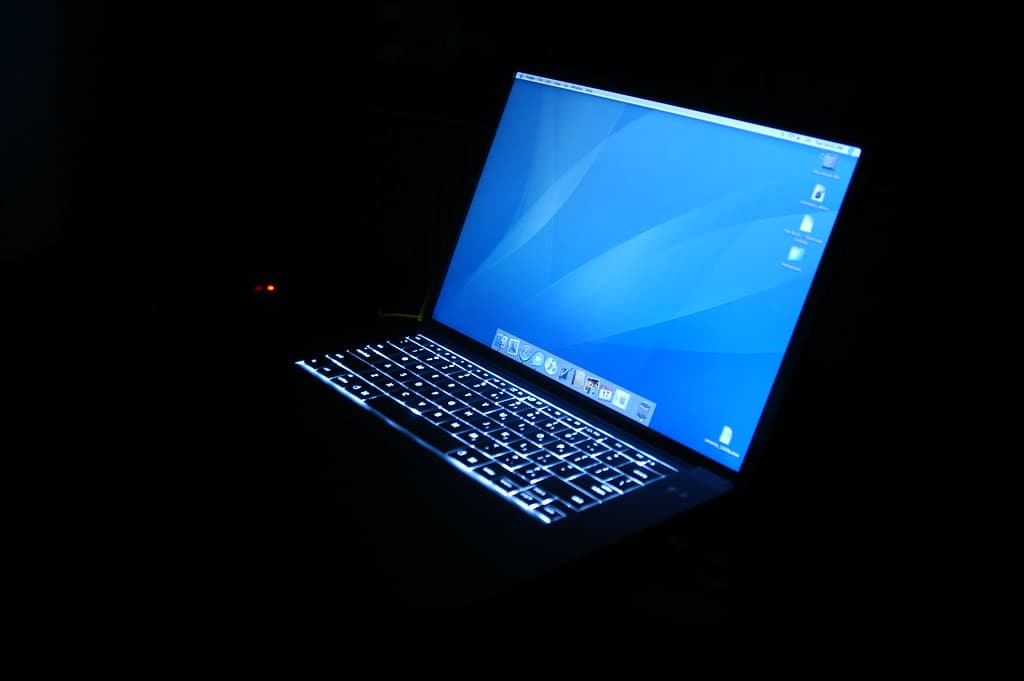 Laptop with a glowing screen in a dark room